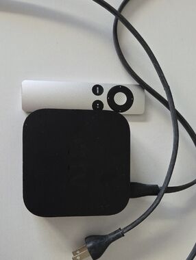 Black Apple TV Streaming Box with Silver Remote